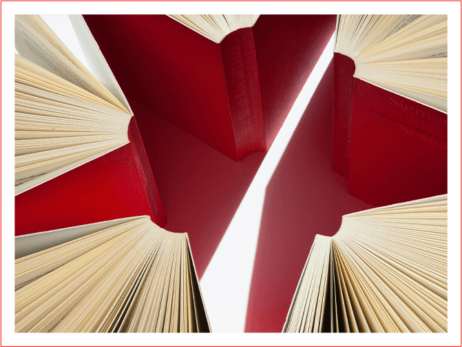 A red star is seen through the pages of an open book.